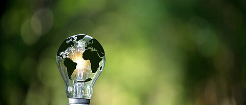 Green world map on light bulb that represents green energy Renewable energy that is important to the world. Renewable Energy. Environmental protection, renewable, sustainable energy sources.