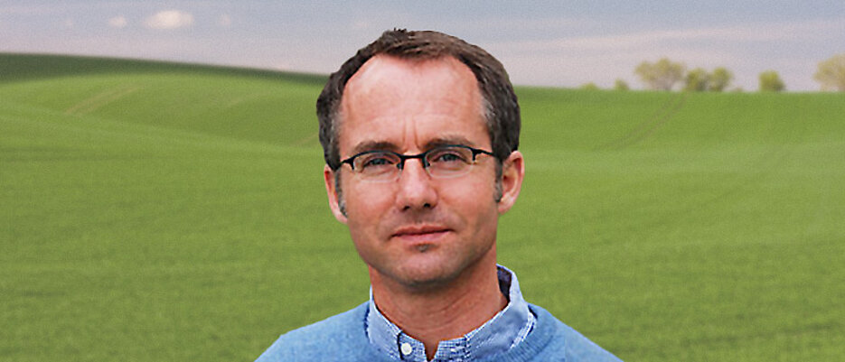 Profilbild von Prof. Dr. Steffen Schlinker vor einer grünen Wiese.